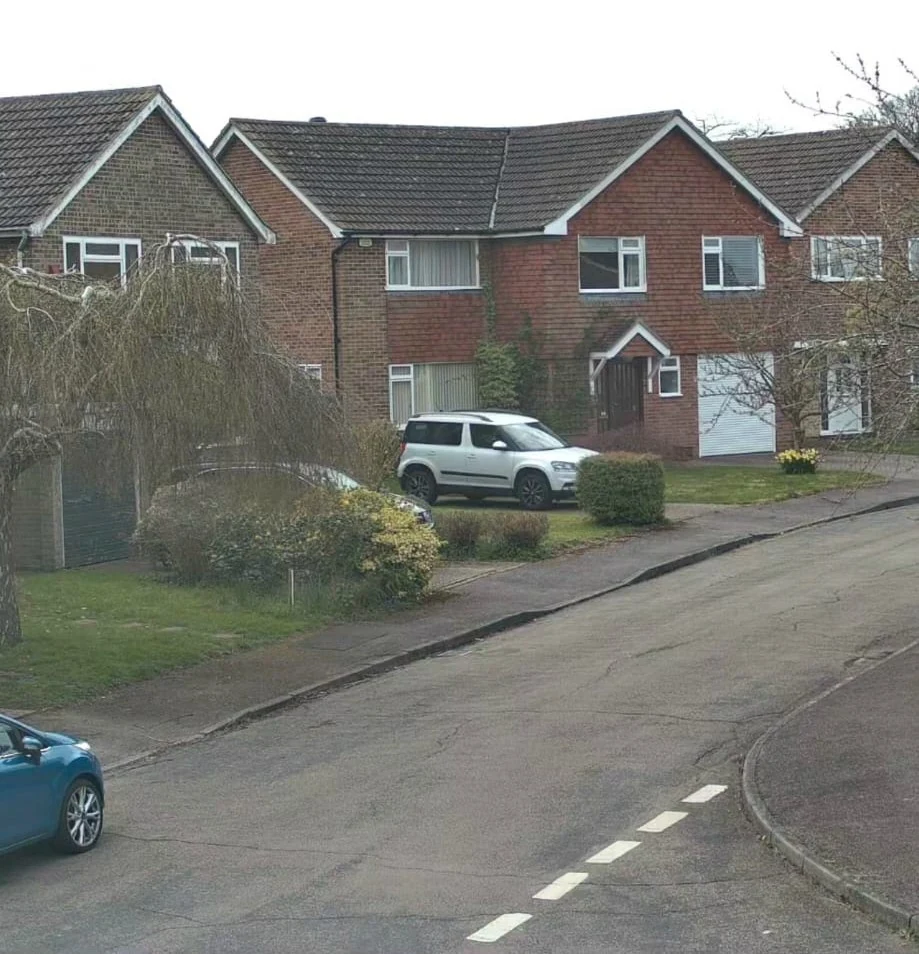 Sharp colour footage of a residential street from a modern IP CCTV camera